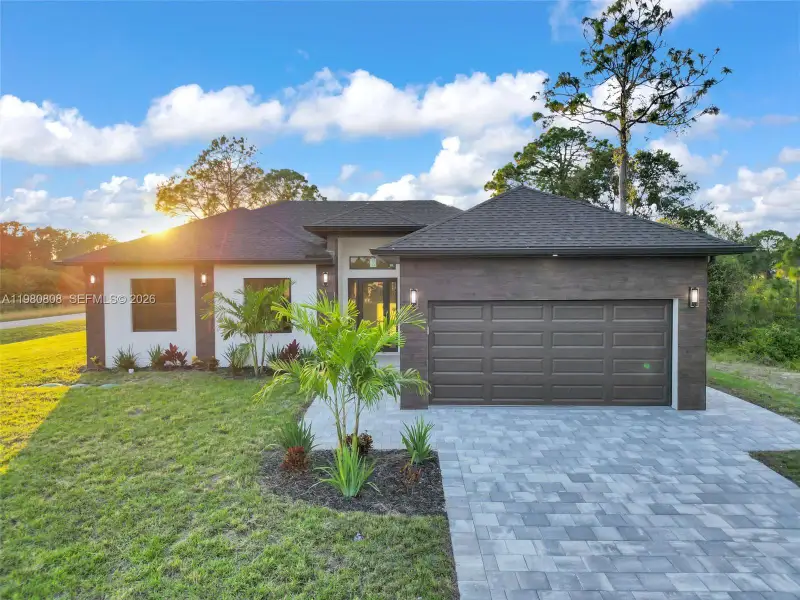 Front exterior of a new home in , Lehigh Acres, FL, highlighting curb appeal (Image 18).