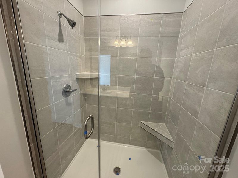 Primary Bath Tile Shower with Semi-frameless glass door and tile wall