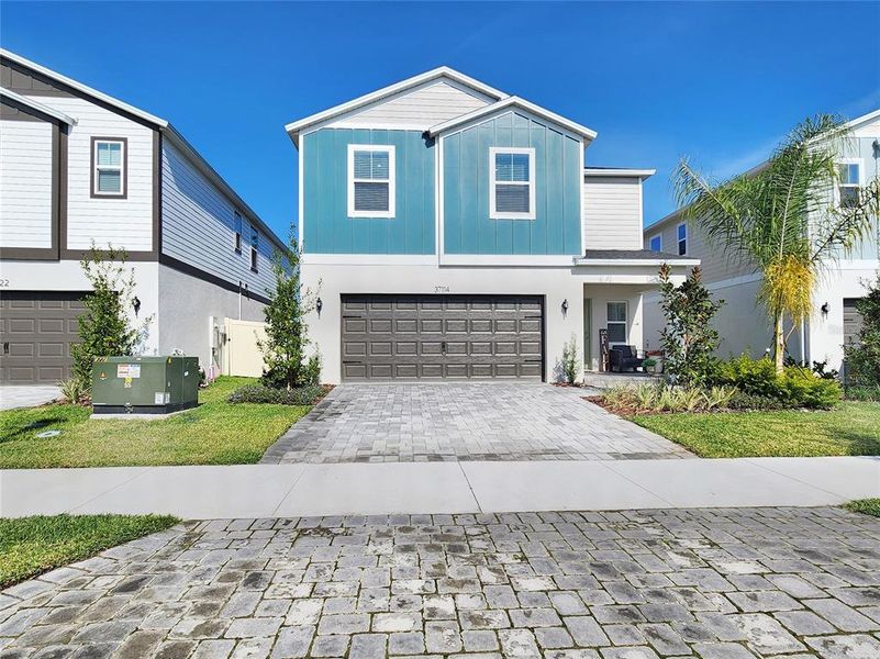 Front exterior of a new home in Two Rivers, Zephyrhills, FL, highlighting curb appeal (Image 25). Front exterior of a new home in Two Rivers, Zephyrhills, FL, highlighting curb appeal (Image 25).