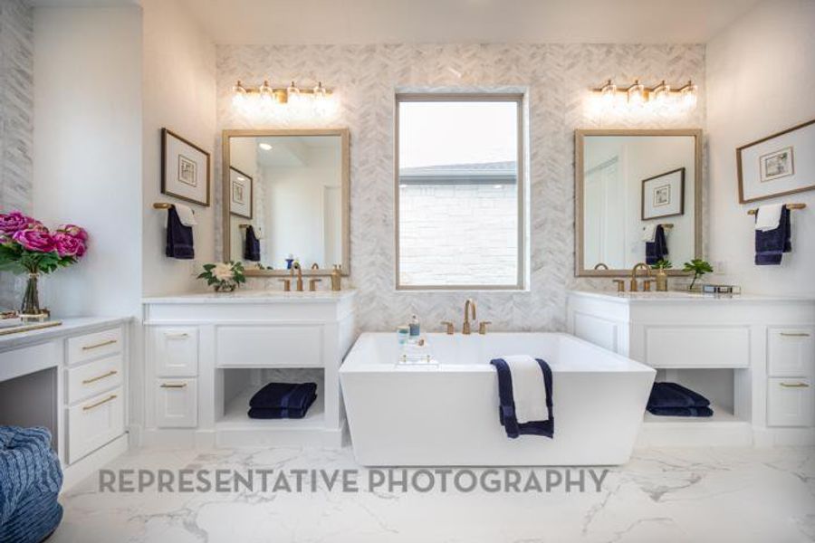 Full bath with marble finish floor, vanity, and a freestanding bath Full bath with marble finish floor, vanity, and a freestanding bath