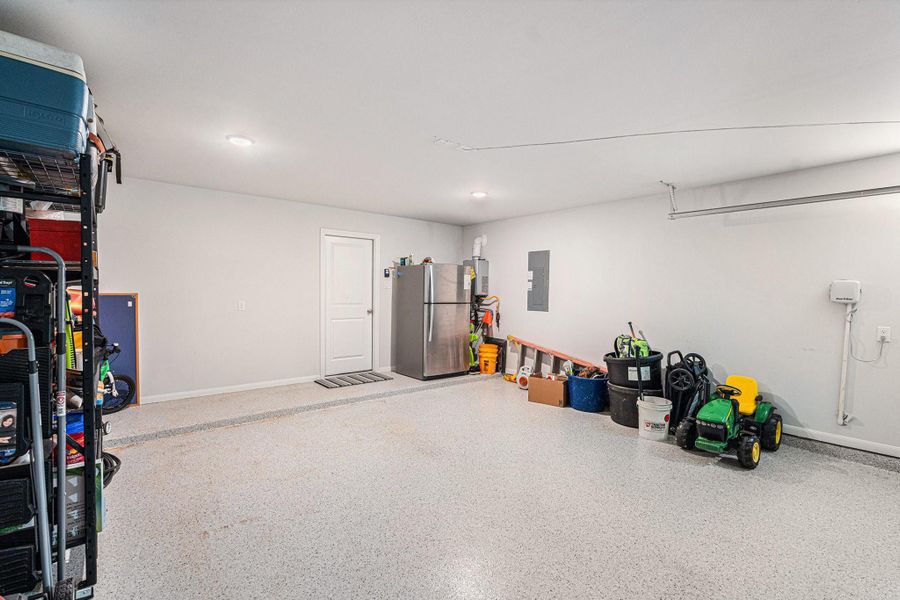 The epoxy garage floor makes for a clean appearance and fast cleanup. The garage door opener is also upgraded for quieter operation. And there's a tankless water heater for efficiency and comfort. The epoxy garage floor makes for a clean appearance and fast cleanup. The garage door opener is also upgraded for quieter operation. And there's a tankless water heater for efficiency and comfort.