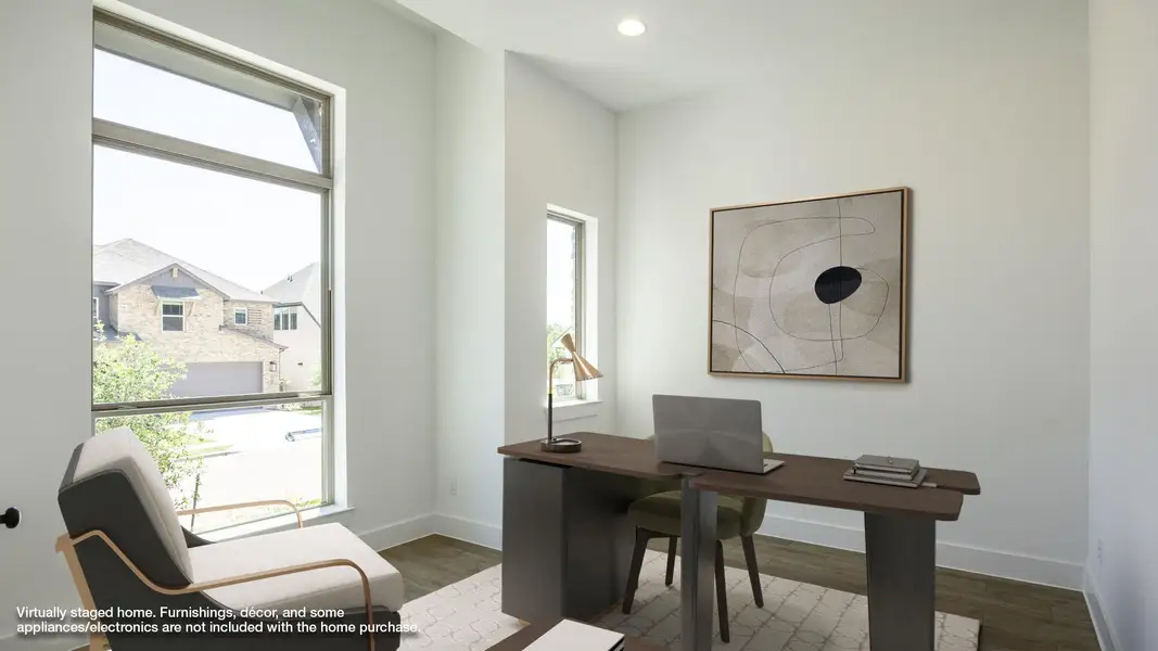 Home office featuring wood finished floors, plenty of natural light, and baseboards Home office featuring wood finished floors, plenty of natural light, and baseboards