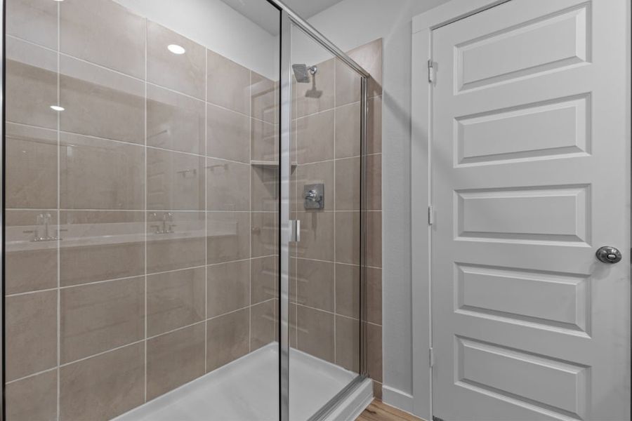 A shower with a glass door. A shower with a glass door.