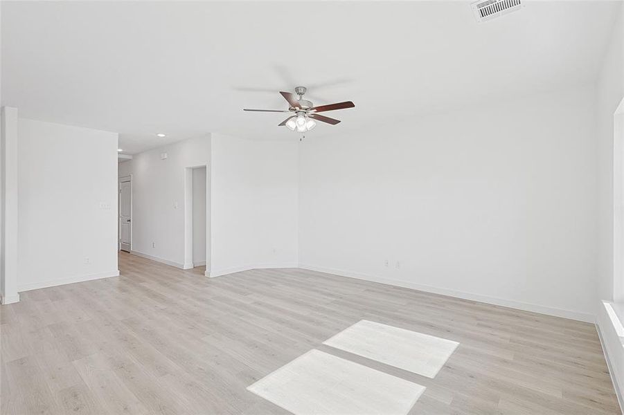 Empty room featuring ceiling fan and light hardwood / wood-style flooring