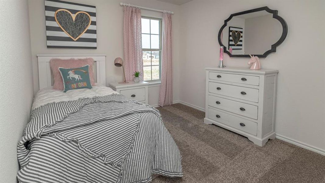 Bedroom featuring textured carpeting, a single window with light-filtering curtains, a built-in closet, and light-toned wall paint