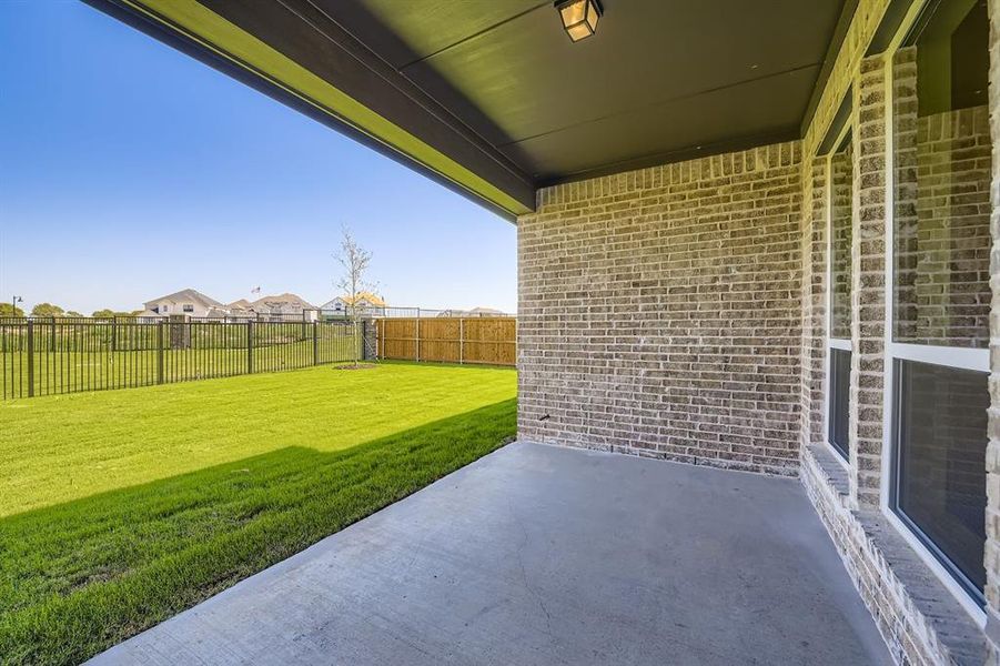 Fenced backyard featuring a patio and a residential view