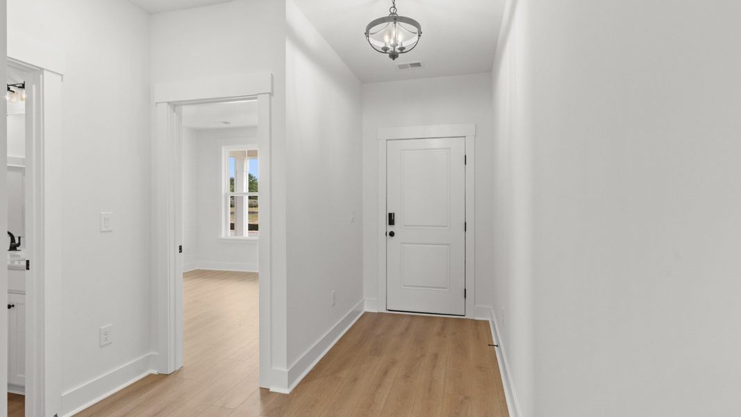Bright hallway connects the main living area to secondary bedrooms with ease.