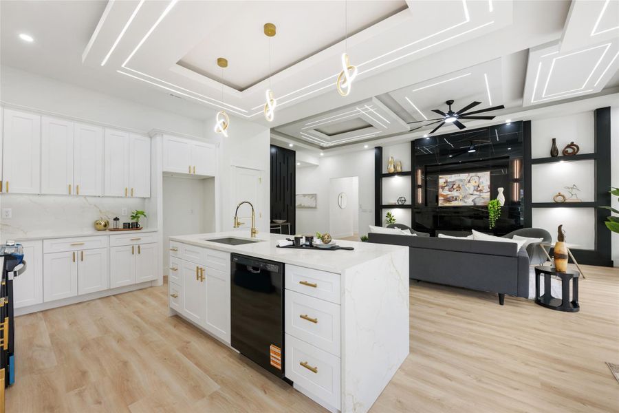 Modern kitchen island with integrated sink and dishwasher, complemented by gold-finish hardware