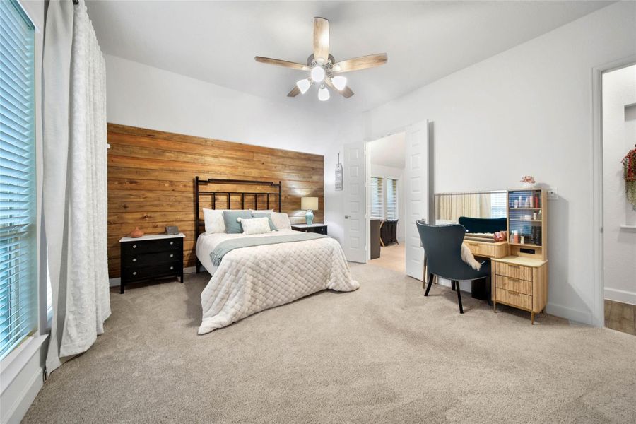 A rustic wood-plank accent wall adds warmth, texture & character to the primary suite, creating a cozy yet sophisticated retreat.
