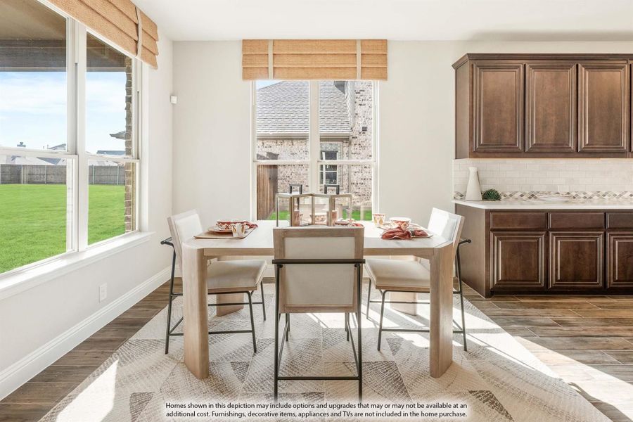 Breakfast nook with light wood dining table, four chairs, large windows, and dark wood kitchen cabinets nearby. Breakfast nook with light wood dining table, four chairs, large windows, and dark wood kitchen cabinets nearby.
