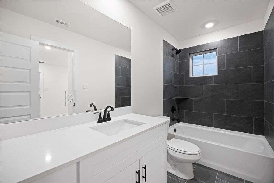 Custom tile flows from the floor up the shower walls Custom tile flows from the floor up the shower walls