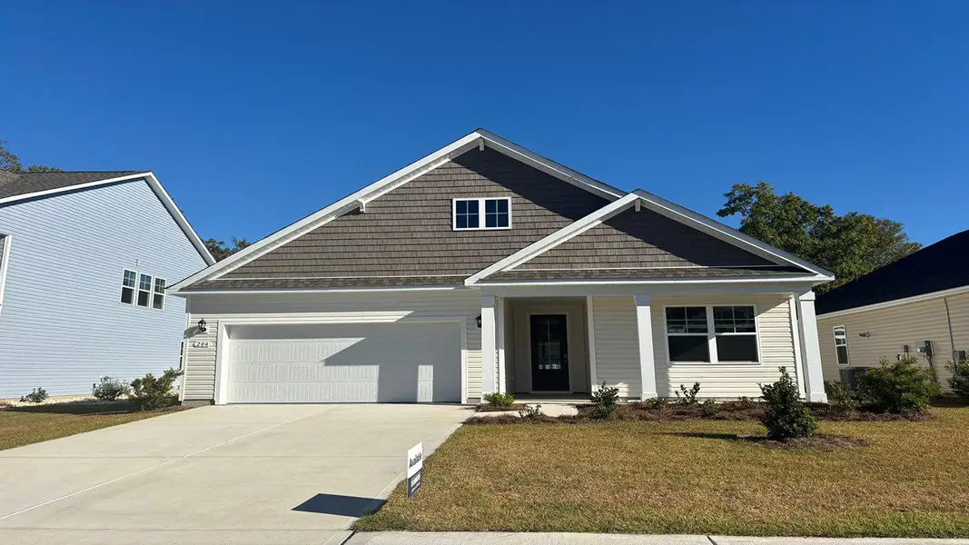Front exterior of a new home in Brunswick Plantation, Ash, NC, highlighting curb appeal (Image 2). Front exterior of a new home in Brunswick Plantation, Ash, NC, highlighting curb appeal (Image 2).
