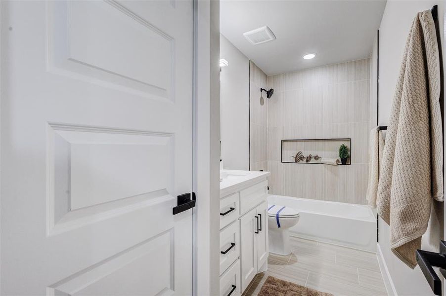 Full bath with vanity, shower / washtub combination, and recessed lighting