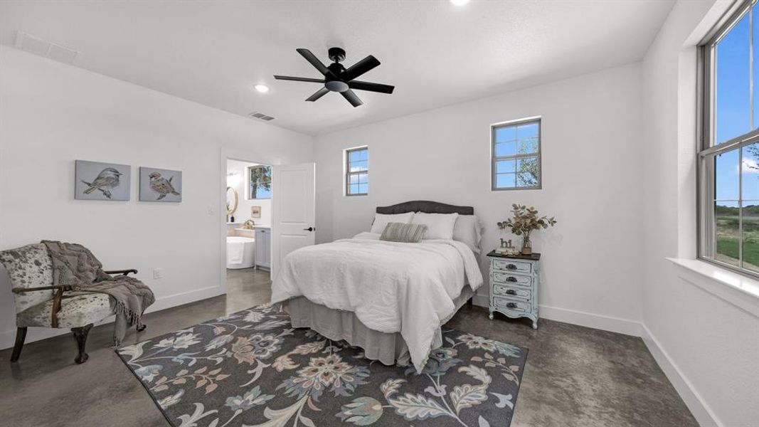 The master bedroom with an ensuite bathroom with double sinks for convenience, a spacious walk-in shower with tiled finishes, and a generously sized closet designed for two people.