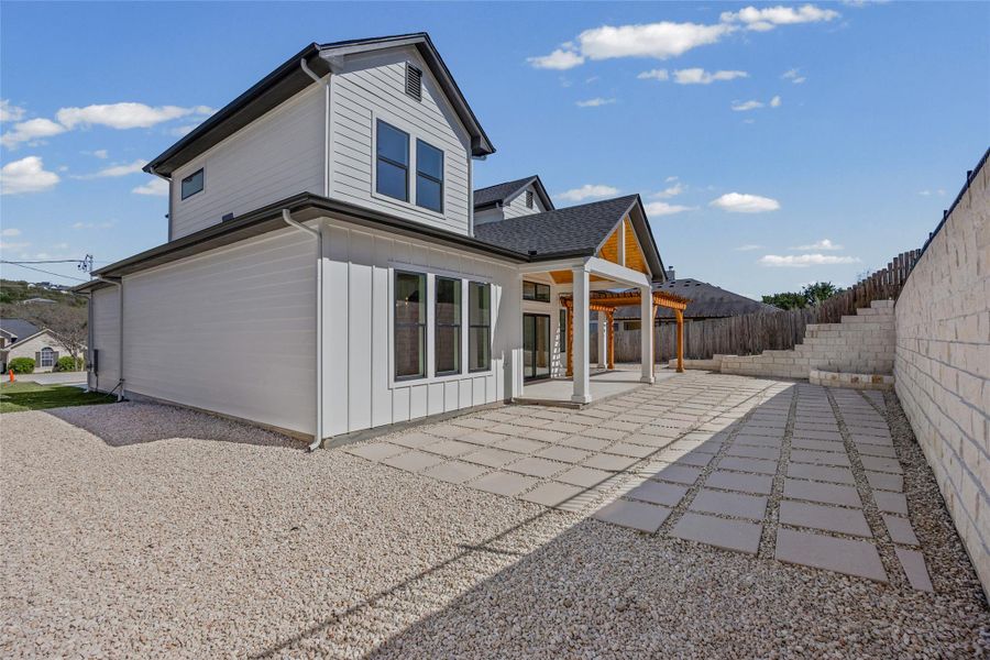 Back of property featuring a patio area, board and batten siding, and a fenced backyard Back of property featuring a patio area, board and batten siding, and a fenced backyard