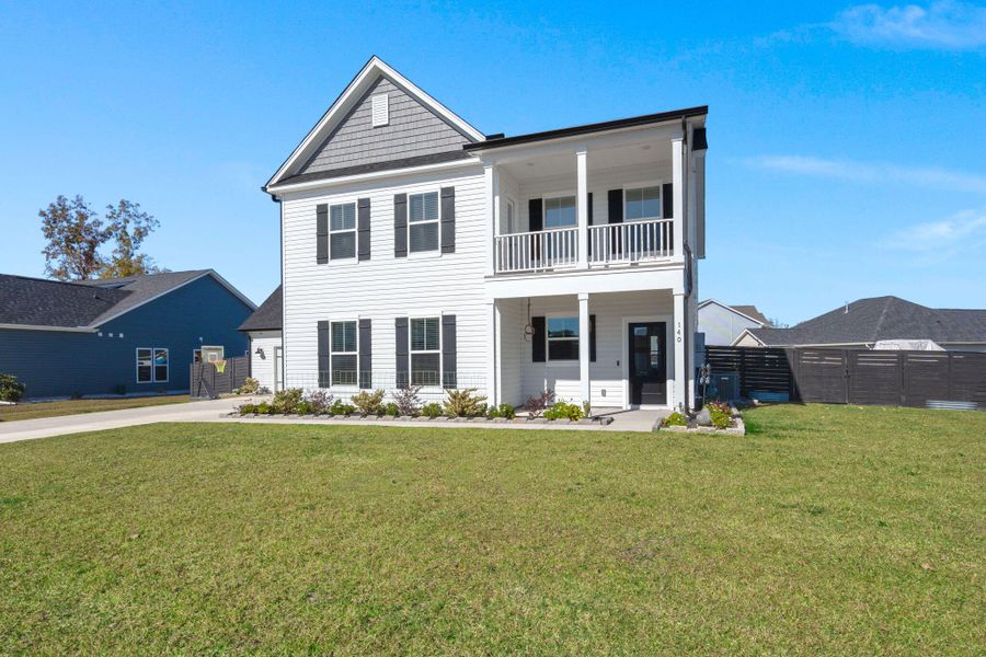 Front exterior of a new home in Timothy Lakes, Ridgeville, SC, highlighting curb appeal (Image 23). Front exterior of a new home in Timothy Lakes, Ridgeville, SC, highlighting curb appeal (Image 23).