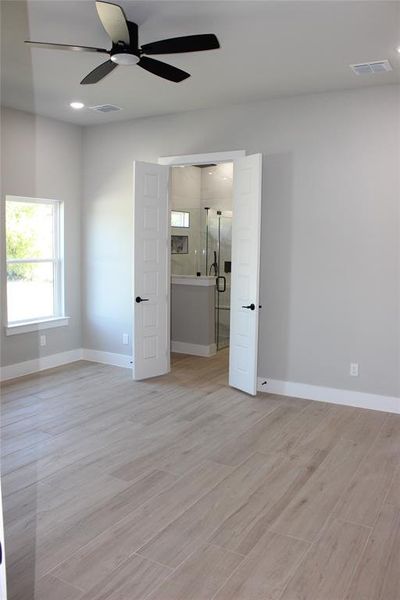 Unfurnished room featuring light hardwood / wood-style flooring and ceiling fan