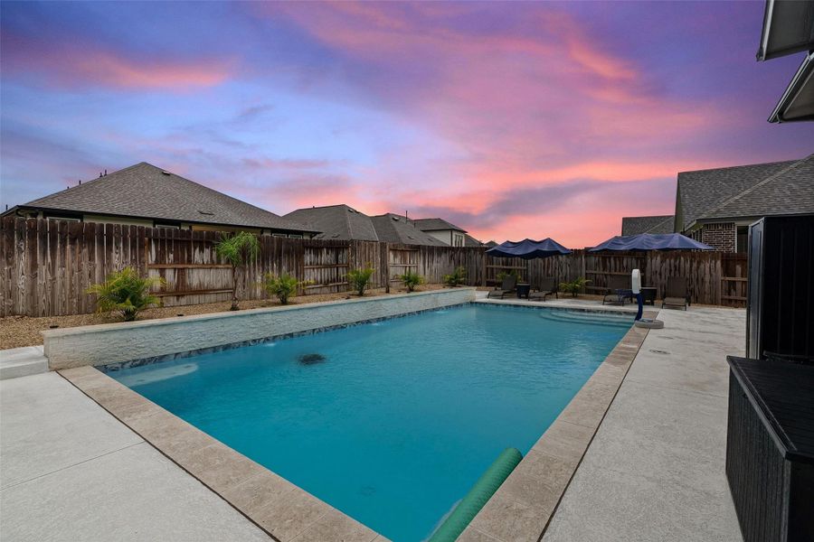 Enjoy a resort-style backyard with heated pool, covered patio, and professional landscaping. Enjoy a resort-style backyard with heated pool, covered patio, and professional landscaping.