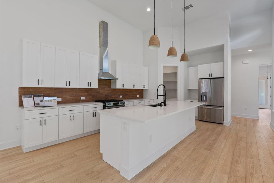 Culinary aspirations come alive in this kitchen, featuring soaring ceilings and a spacious island.