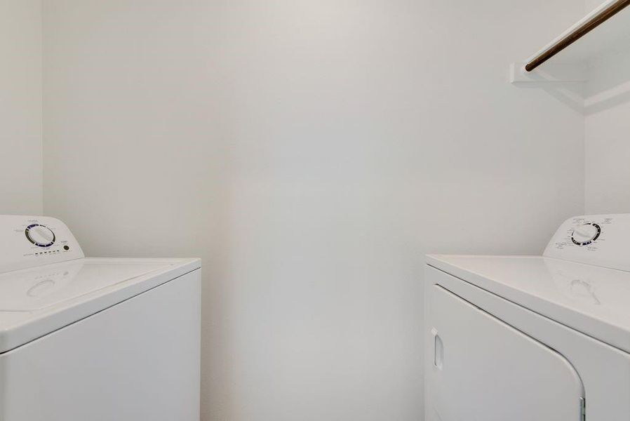 Washroom featuring washing machine and dryer and laundry area