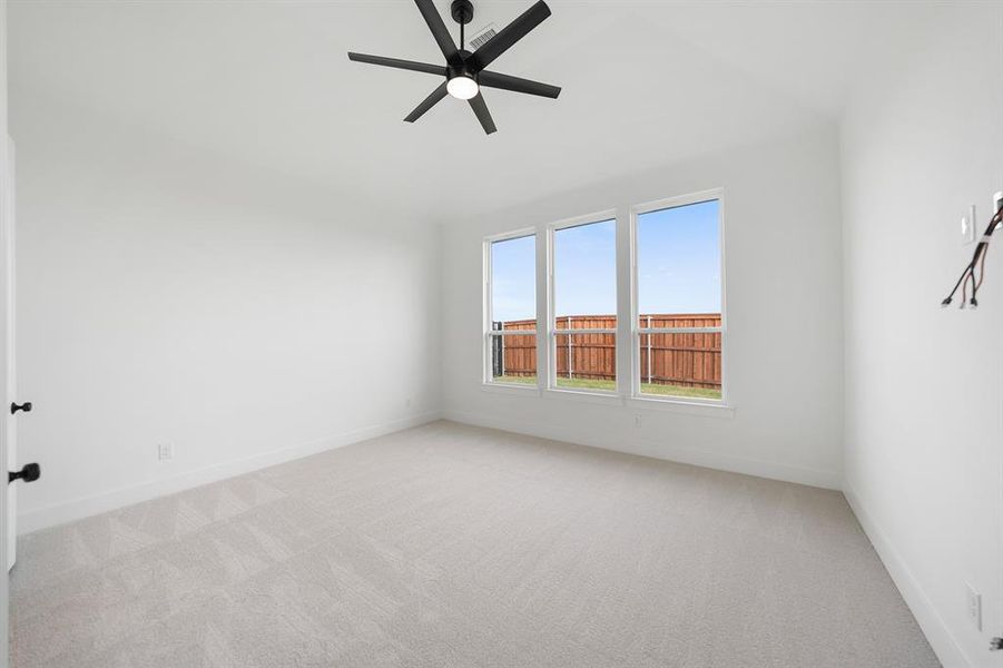 Spare room featuring carpet floors and ceiling fan