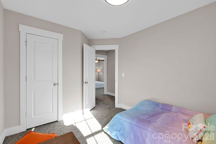 A bright secondary bedroom perfect for guests, a home office, or flex space.