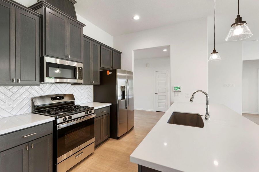 The kitchen is equipped with stainless steel appliances and offers ample storage.