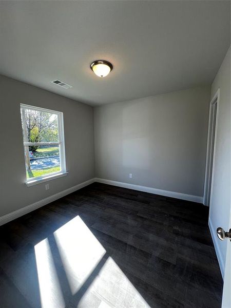 Spare room featuring dark hardwood / wood-style floors