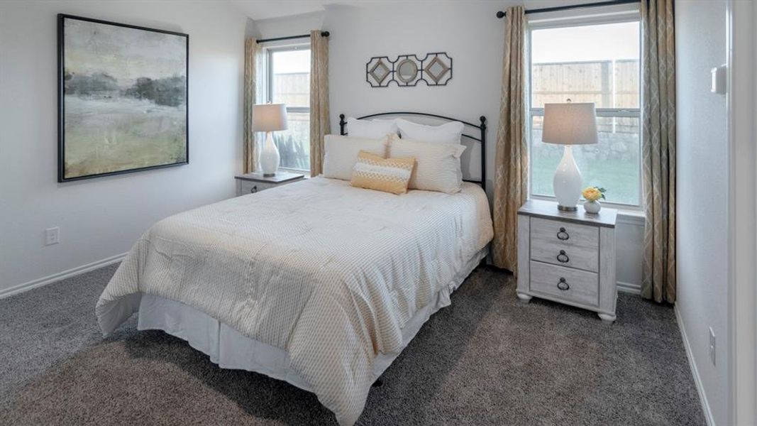 Carpeted interior space featuring white walls and two windows with drapes Carpeted interior space featuring white walls and two windows with drapes