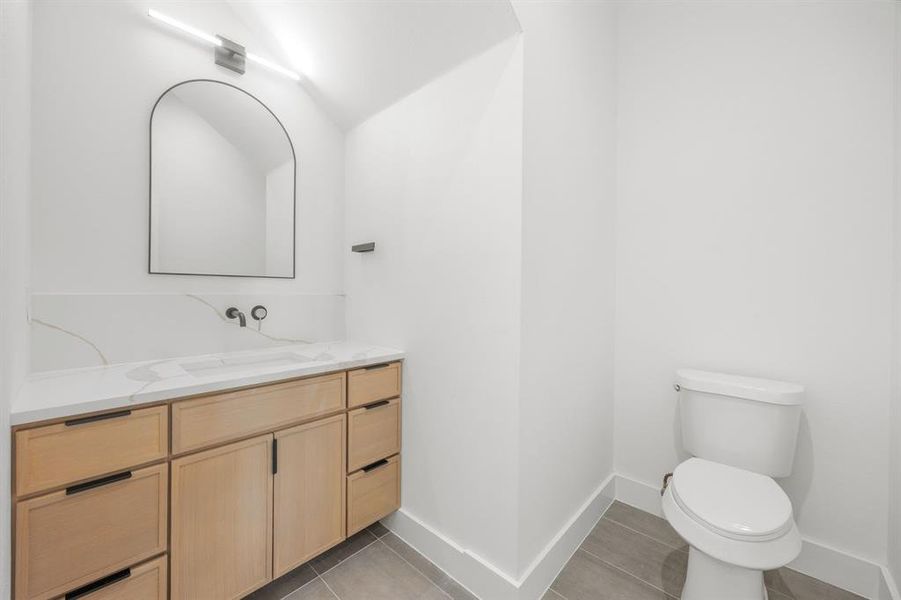The guest powder bath is conveniently located just outside the office at the front of the home, offering visitors a private and sophisticated space with both comfort and elegance in mind. The guest powder bath is conveniently located just outside the office at the front of the home, offering visitors a private and sophisticated space with both comfort and elegance in mind.