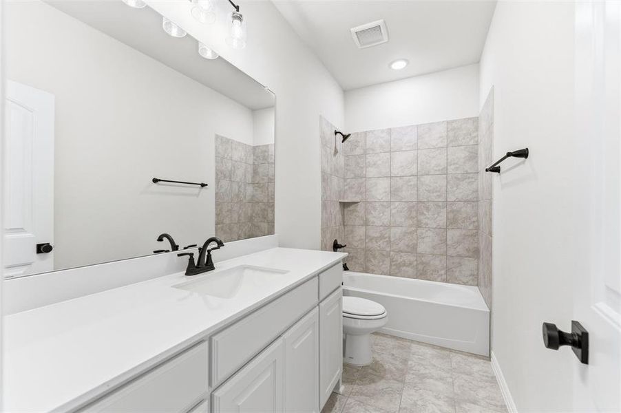 Bathroom featuring vanity and shower / bathtub combination