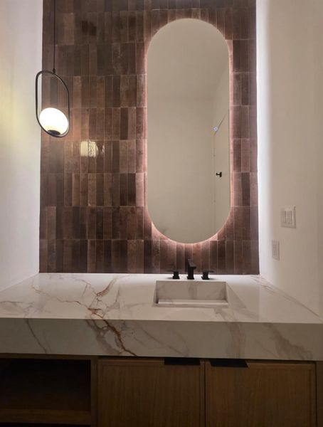 Luxurious Powder Bath with Integrated Quartzite Sink is the ultimate expression of architectural minimalism. The stone seamlessly drops down into the basic, creating a monolithic, uninterrupted look