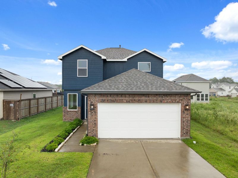 Front exterior of a new home in Santa Fe, Cleveland, TX, highlighting curb appeal (Image 18). Front exterior of a new home in Santa Fe, Cleveland, TX, highlighting curb appeal (Image 18).