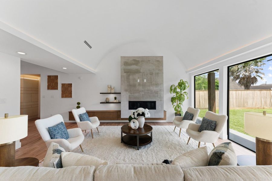 Anchored by a custom concrete fireplace and floating oak shelving with integrated lighting — modern artistry meets real life. Anchored by a custom concrete fireplace and floating oak shelving with integrated lighting — modern artistry meets real life.