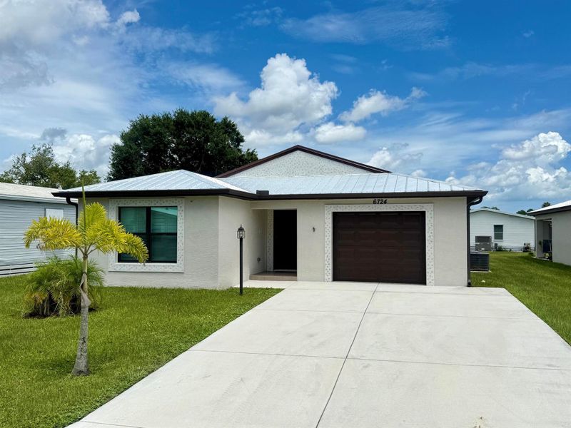 Front exterior of a new home in , Fort Pierce, FL, highlighting curb appeal (Image 28).