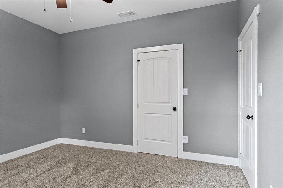 Unfurnished bedroom with carpet, a ceiling fan, and a closet Unfurnished bedroom with carpet, a ceiling fan, and a closet