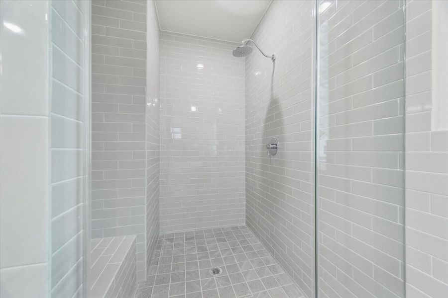 primary bathroom, oversized shower w. porcelain subway tile, resting step.
