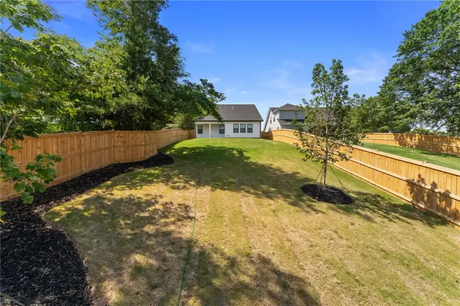 A generously sized yard, fully fenced and meticulo