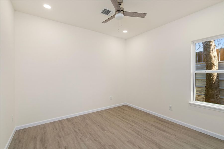 Generously sized bedroom with neutral tones and plenty of natural light.