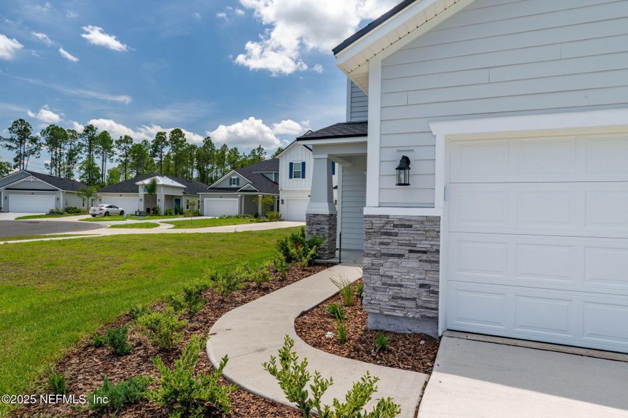 Front exterior of a new home in Beacon Lake, St. Augustine, FL, highlighting curb appeal (Image 39).