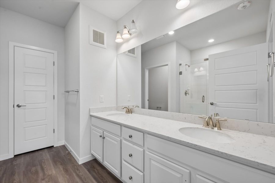 A bathroom with white cabinets. A bathroom with white cabinets.