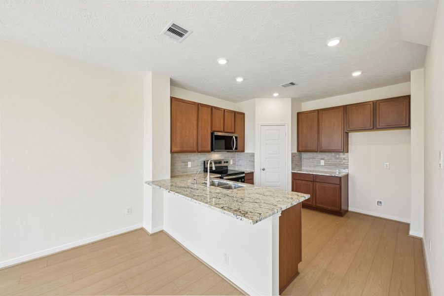 This spacious kitchen has it all—ample storage, generous counter space, and a layout that truly makes it the heart of the home. This spacious kitchen has it all—ample storage, generous counter space, and a layout that truly makes it the heart of the home.