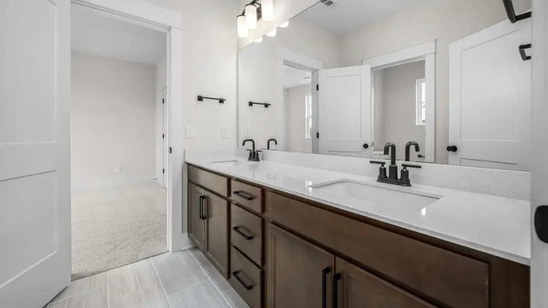 Connected bathroom to two rooms with dual vanity