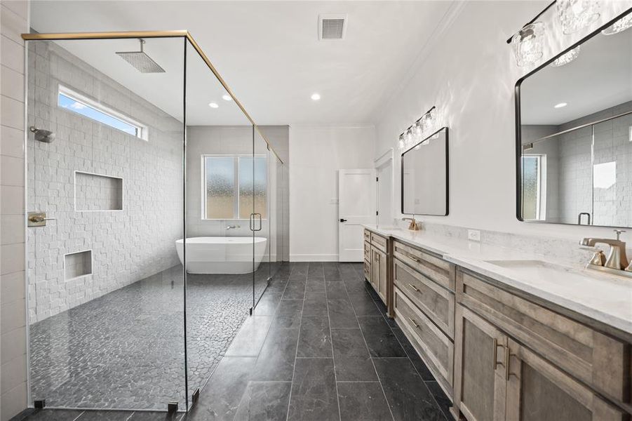 Spacious bathroom with a walk-in shower featuring a rainfall showerhead and pebble floor