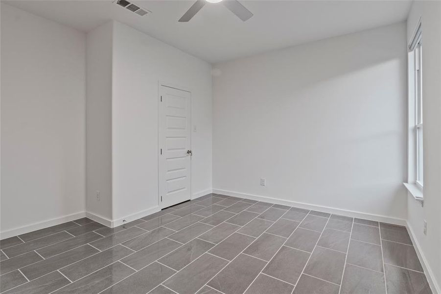 Unfurnished room with ceiling fan and a healthy amount of sunlight