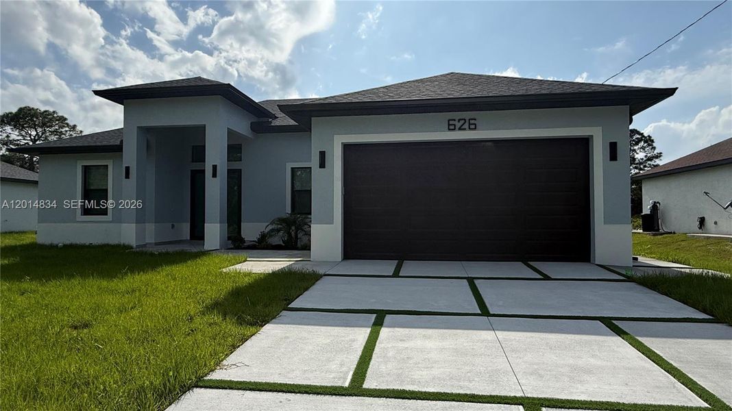 Front exterior of a new home in , Lehigh Acres, FL, highlighting curb appeal (Image 32).