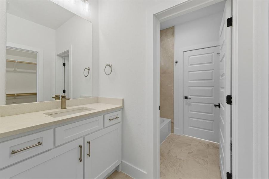 Full bath featuring vanity, shower / bathtub combination, and a spacious closet