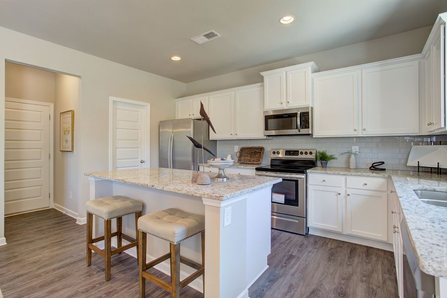 Kitchen area with large corner pantry