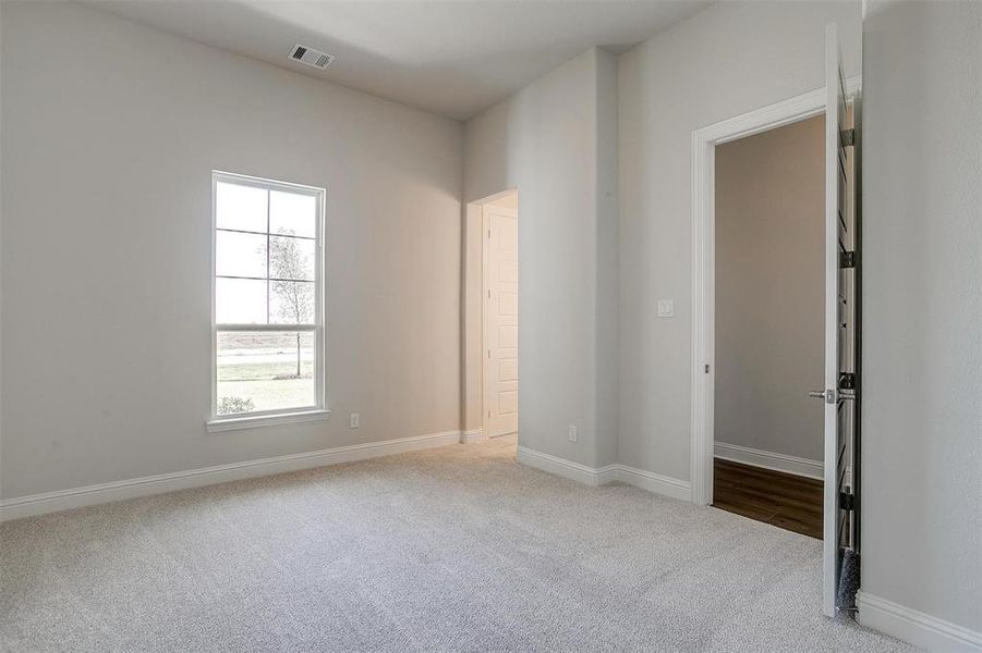 Unfurnished bedroom featuring light carpet