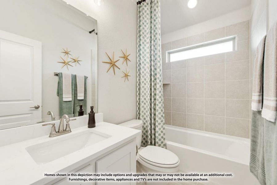 Bathroom with white vanity, tub-shower combo with tile surround, and large mirror